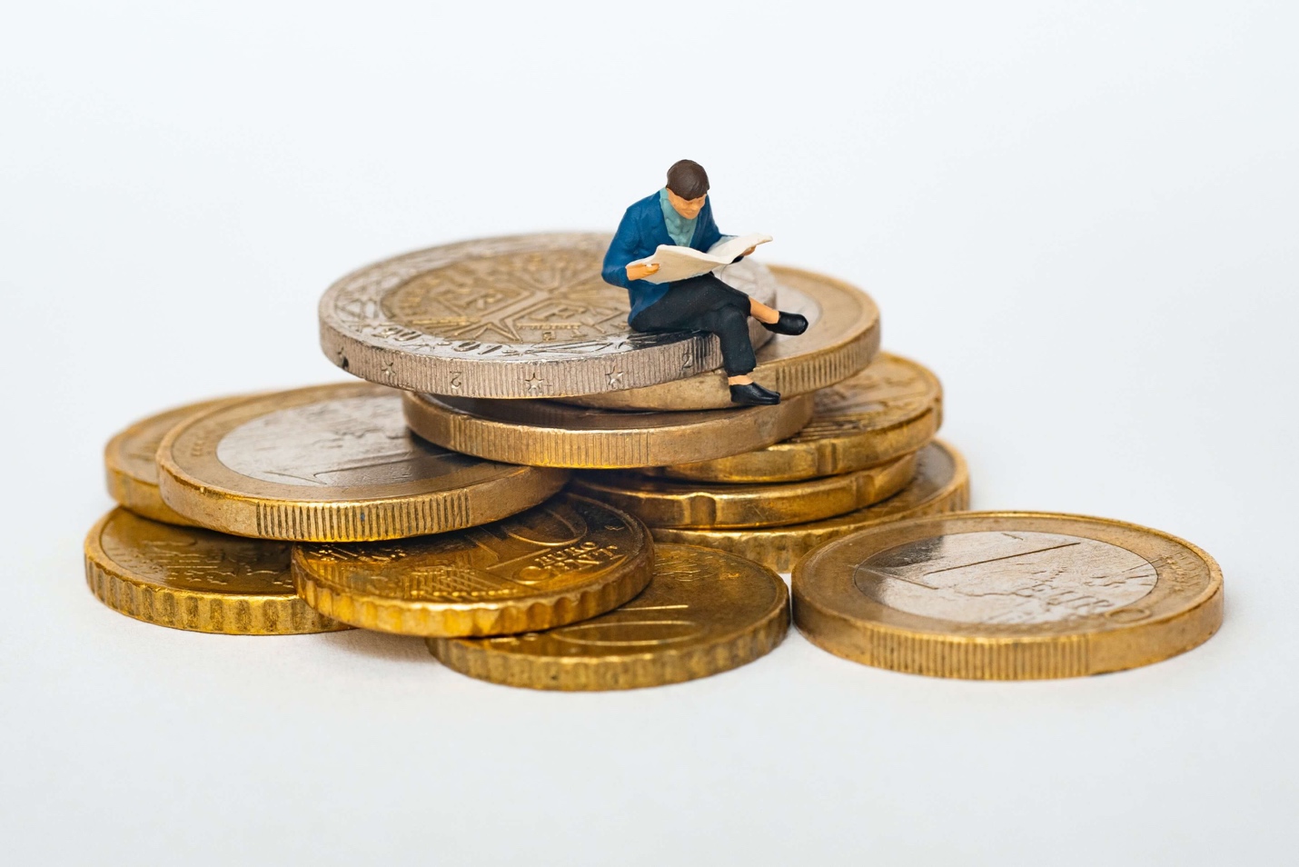 figure man sitting on gold coins