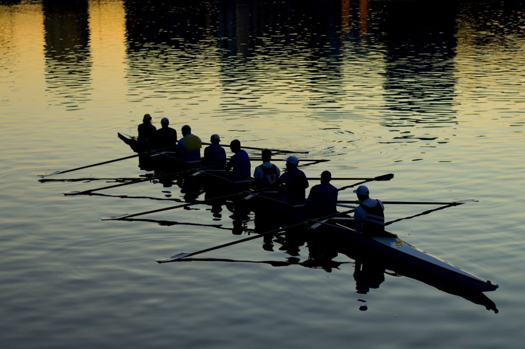 men in boat navigating lake